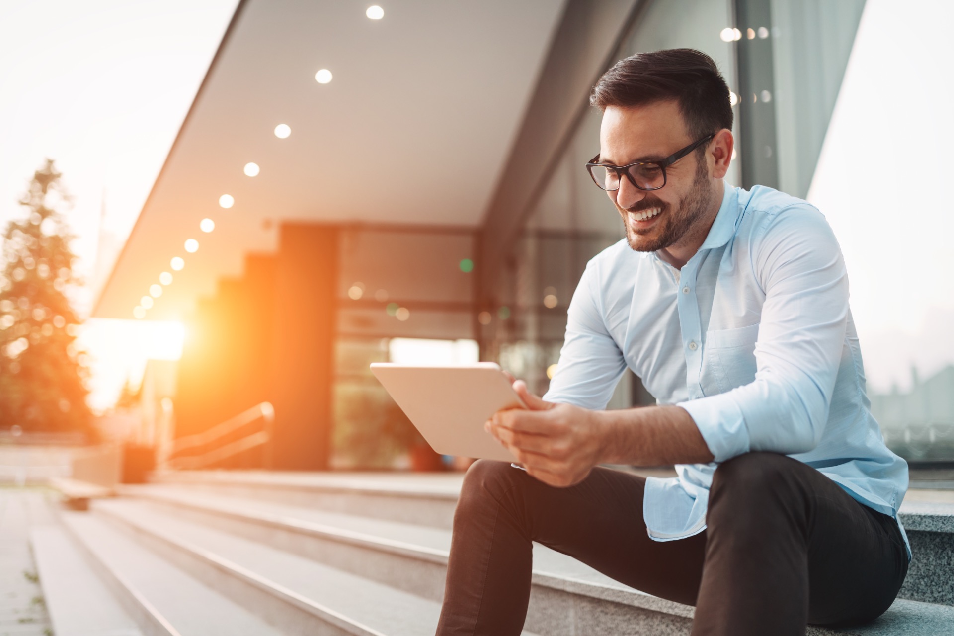 man on stairs with tablet